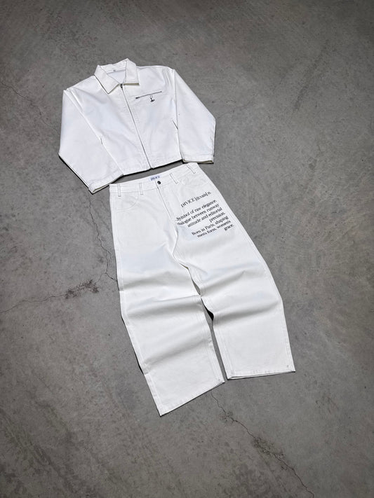 Veste blanche signature DIVICE – posée à plat avec le jean blanc